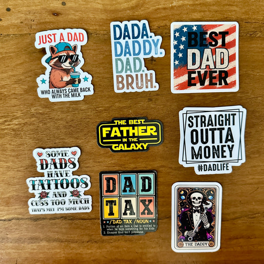 Collection of dad-themed stickers on a wooden surface